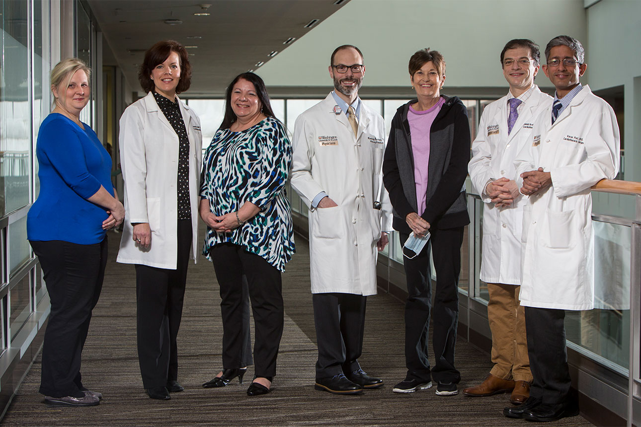 Medical director of lung transplantation Dr. Ramsey Hachem, associate professor of medicine, (center) is joined by the team who performed Barnes-Jewish Hospital patient Michele Coleman's lung transplant in the spring of 2016. Coleman's lungs were reconditioned by a device undergoing testing to expand the donor pool. From left: Laura Ebel, RN, MSN, CCTC, post-transplant coordinator; Jennifer Bell, RN, BSN, CCRC, manager of clinical trials; Masina Scavuzzo, RN, BSN, CCTC, pre-transplant coordinator; Hachem; Coleman; Daniel Kreisel, MD, PhD, professor of surgery and of pathology and immunology; and Varun Puri, MD, associate professor of surgery.